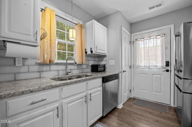 a kitchen with stainless steel appliances granite countertop a stove and a microwave