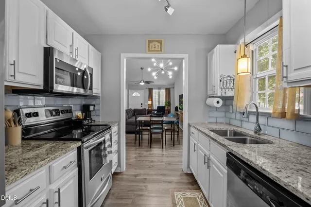 a bathroom with a granite countertop toilet sink and mirror