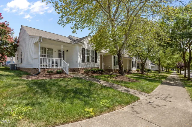 a backyard of a house with yard and outdoor seating
