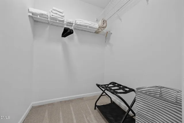 a spacious bedroom with a bed and a dresser