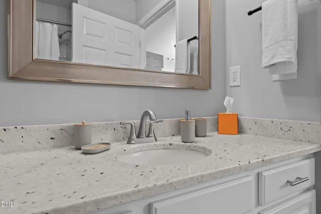 a bedroom with a bed and a night stand