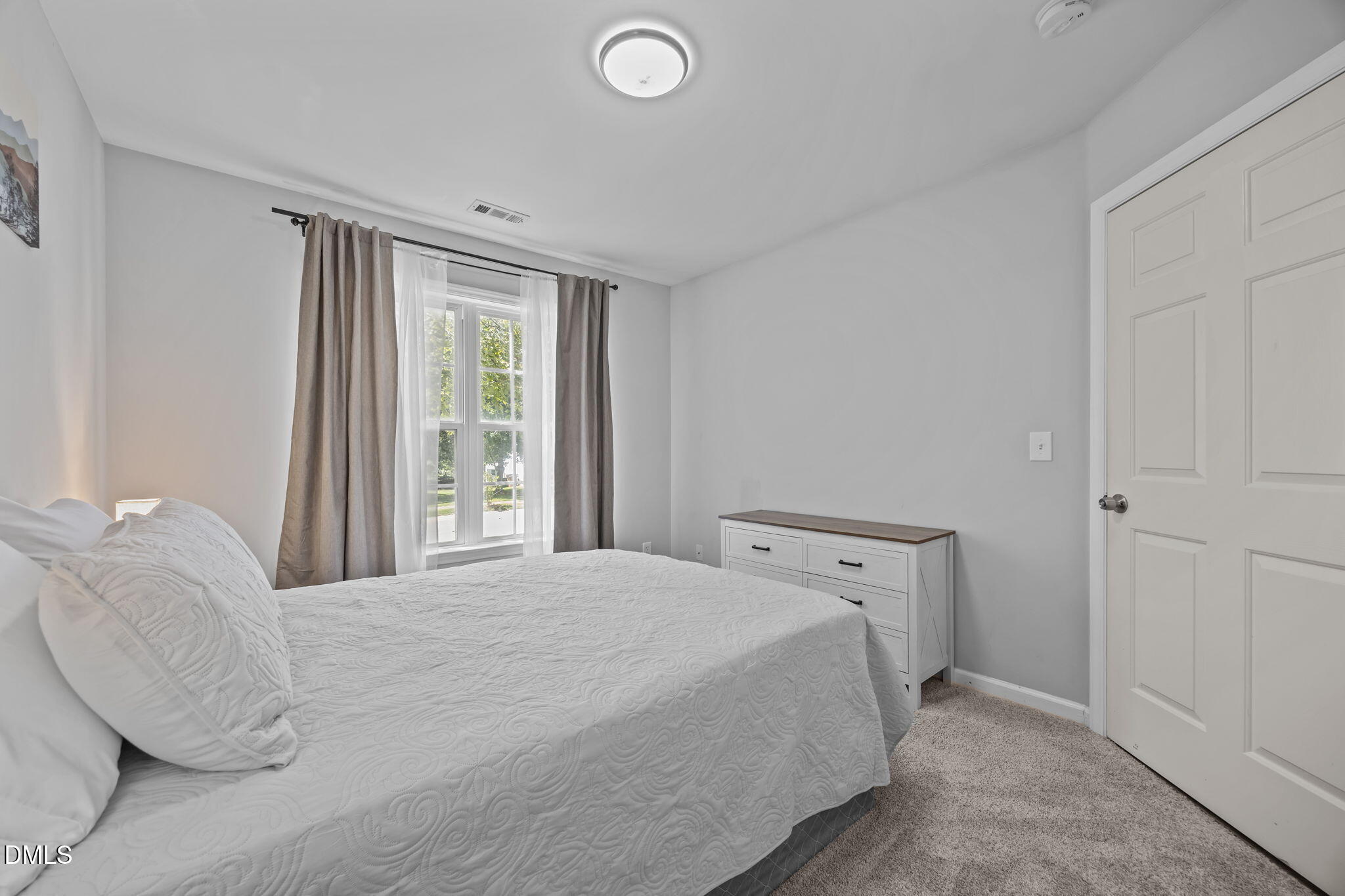 231 Highgate Circle Wake Forest, NC 27587 - Photo 35 of 61 a bedroom with a bed and a window