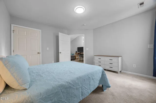 a bathroom with a granite countertop sink a mirror and shower view