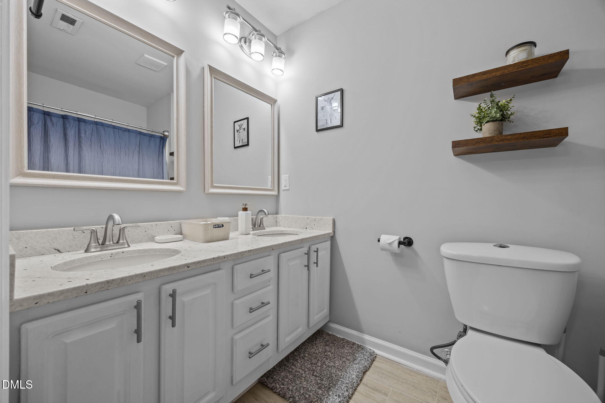 231 Highgate Circle Wake Forest, NC 27587 - Photo 44 of 61 a bathroom with a toilet sink and mirror