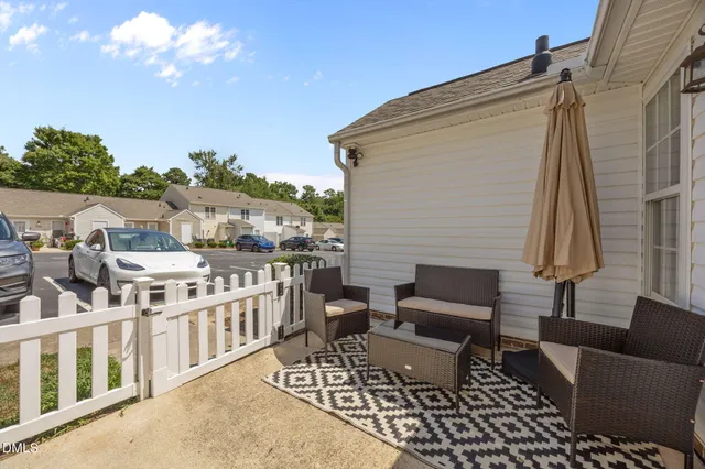 an aerial view of residential houses with outdoor space and trees
