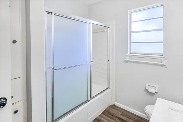 a bathroom with a shower and a toilet
