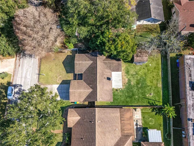 an aerial view of a house with garden space and street view