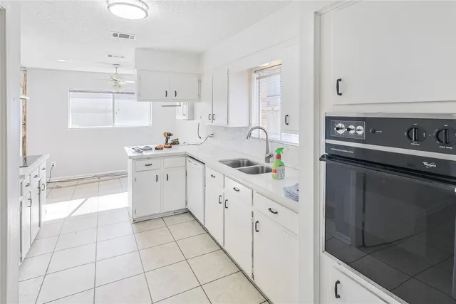 a kitchen with stainless steel appliances a sink stove and cabinets