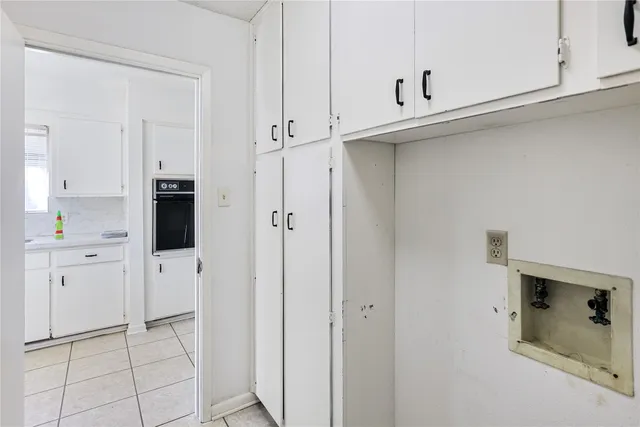 a view of a kitchen with white cabinets