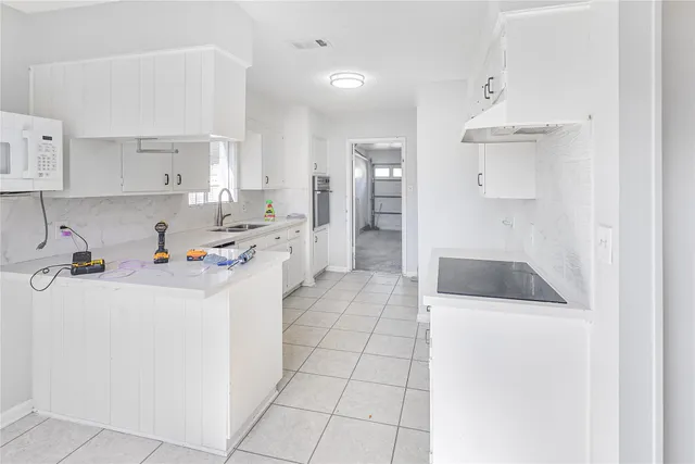 a kitchen with stainless steel appliances a refrigerator sink and cabinets