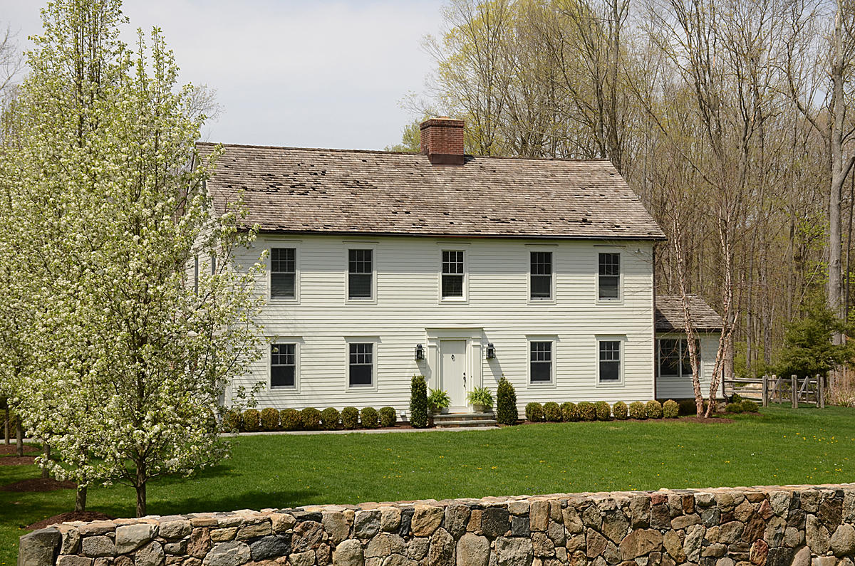 a view of a white house with a yard
