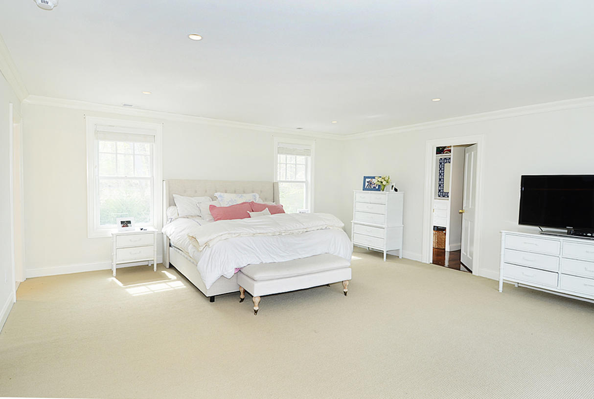 277 Country Club Road New Canaan, CT 06840 - Photo 14 of 29 a bedroom with a bed and a flat screen tv