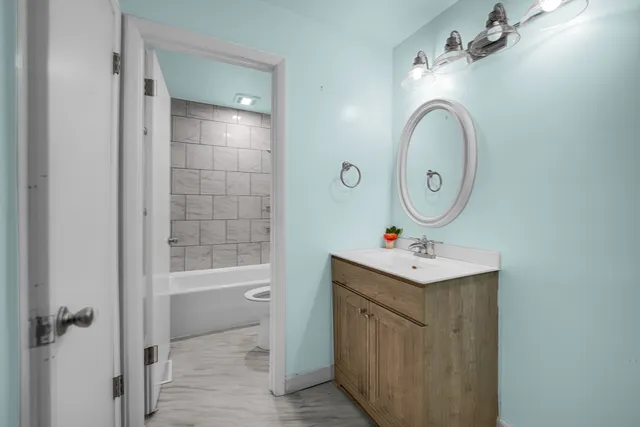 a bathroom with a sink mirror vanity and toilet