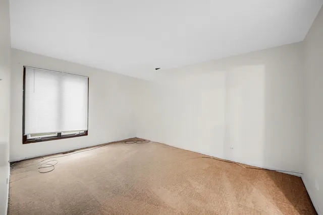 a view of an empty room and a window