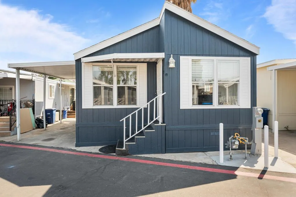 255 East Bradley Avenue, Unit SPC 79 El Cajon, CA 92020 - Photo 1 of 22 a front view of a house with a garage