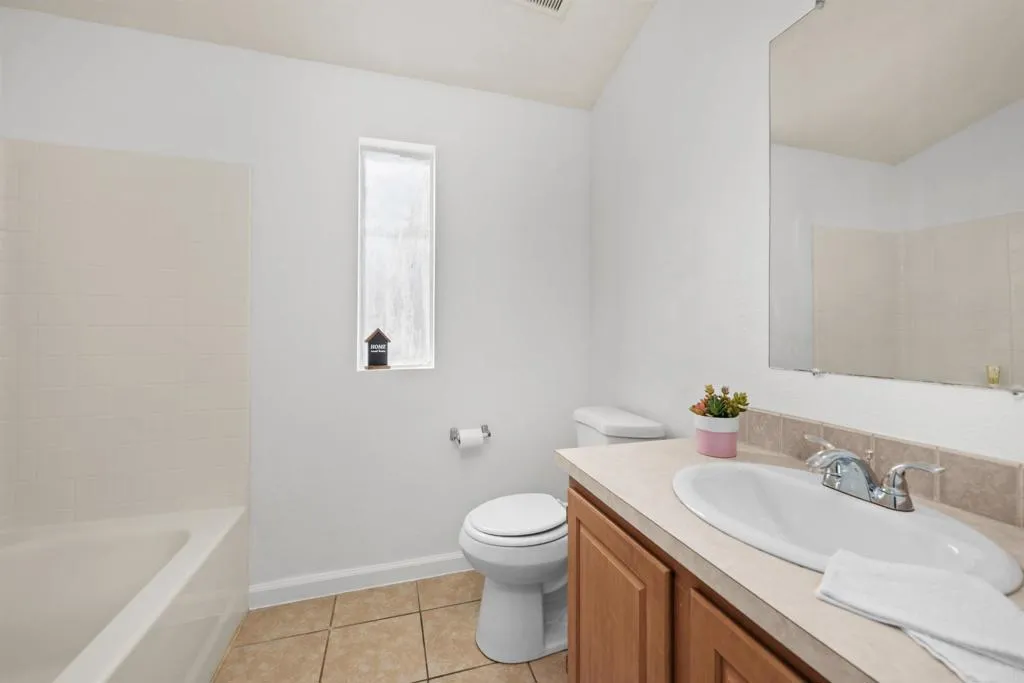 255 East Bradley Avenue, Unit SPC 79 El Cajon, CA 92020 - Photo 11 of 22 a bathroom with a granite countertop sink a toilet and a bathtub