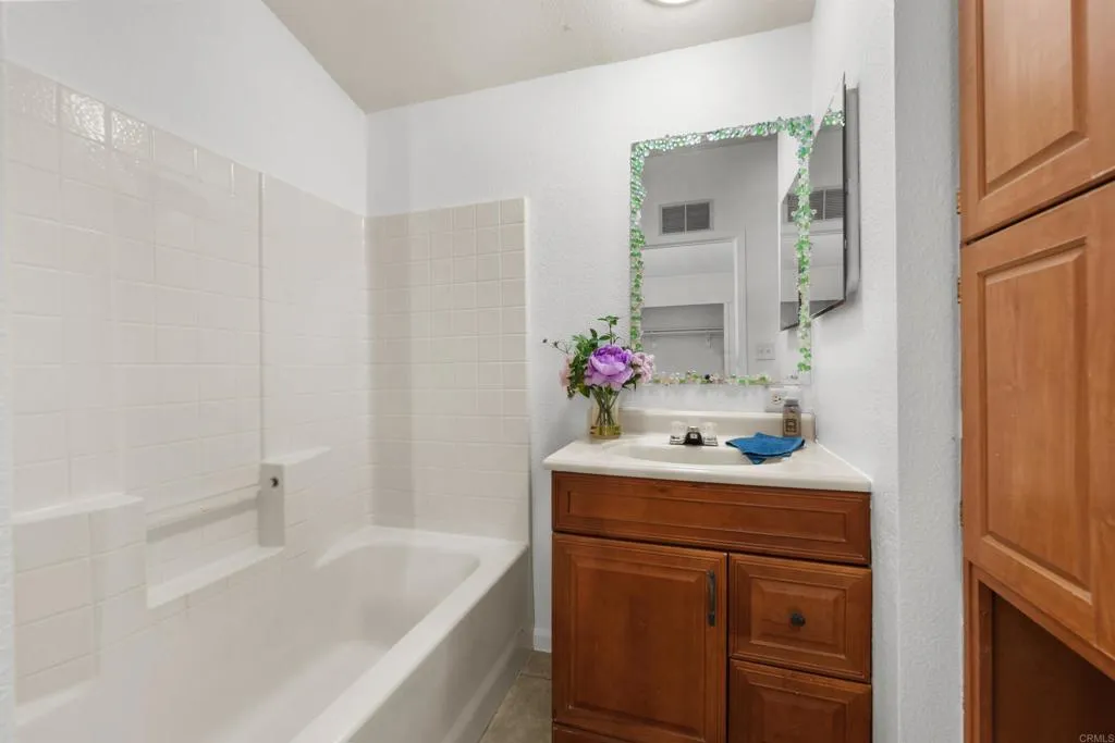 255 East Bradley Avenue, Unit SPC 79 El Cajon, CA 92020 - Photo 14 of 22 a bathroom with a sink vanity granite tub and shower