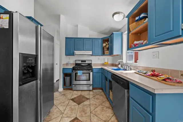 a kitchen with stainless steel appliances granite countertop a refrigerator stove and oven