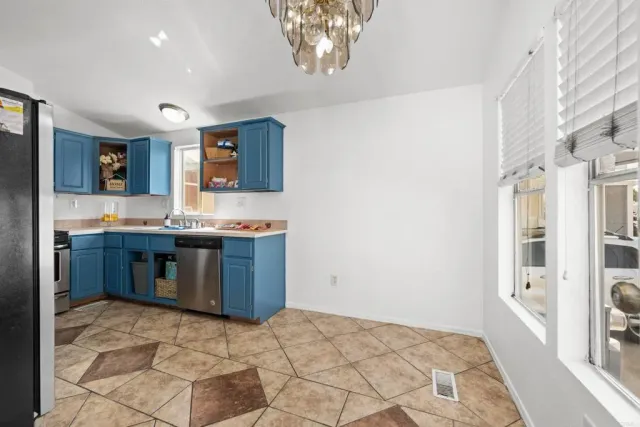 a kitchen with stainless steel appliances granite countertop a stove a sink and a refrigerator