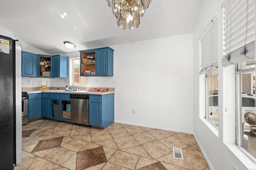255 East Bradley Avenue, Unit SPC 79 El Cajon, CA 92020 - Photo 5 of 22 a kitchen with stainless steel appliances granite countertop a stove a sink and a refrigerator