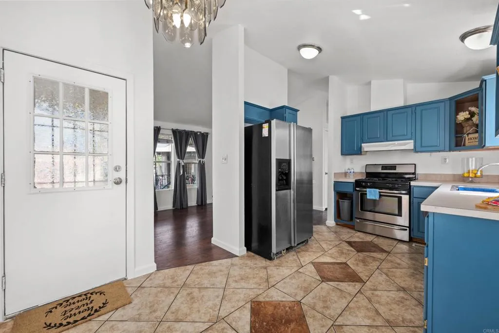 255 East Bradley Avenue, Unit SPC 79 El Cajon, CA 92020 - Photo 6 of 22 a kitchen with granite countertop a refrigerator and a stove top oven
