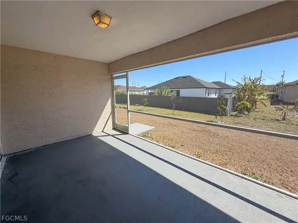 a view of a room with a floor to ceiling window and an outdoor view