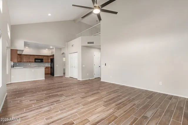 a view of a kitchen with a sink and a refrigerator