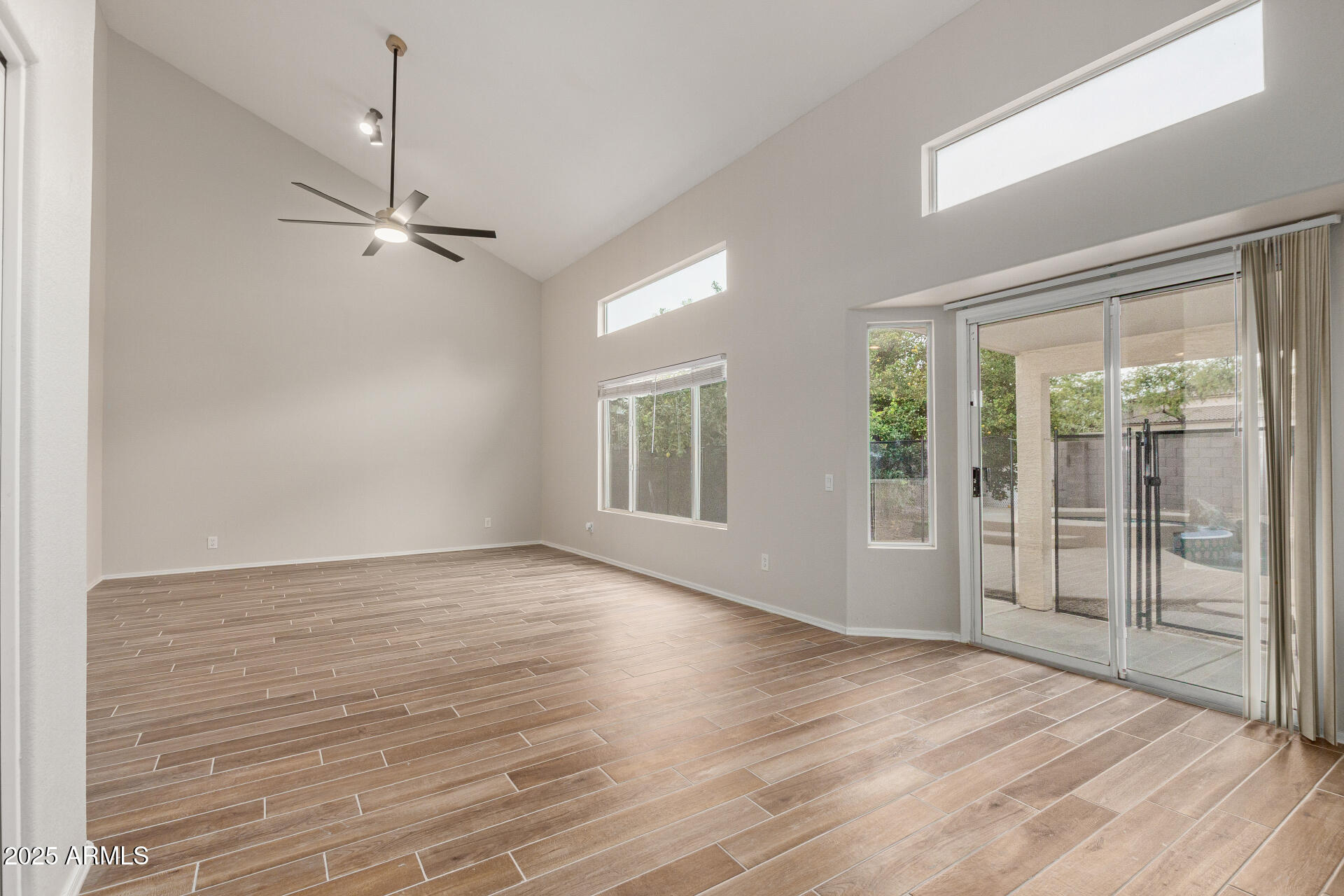 4522 East Rowel Road Phoenix, AZ 85050 - Photo 18 of 49 an empty room with wooden floor cabinet and windows