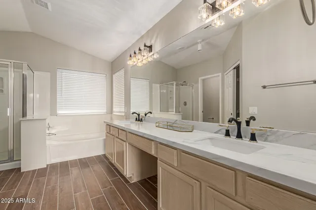 a bathroom with a double vanity sink a mirror and a bathtub