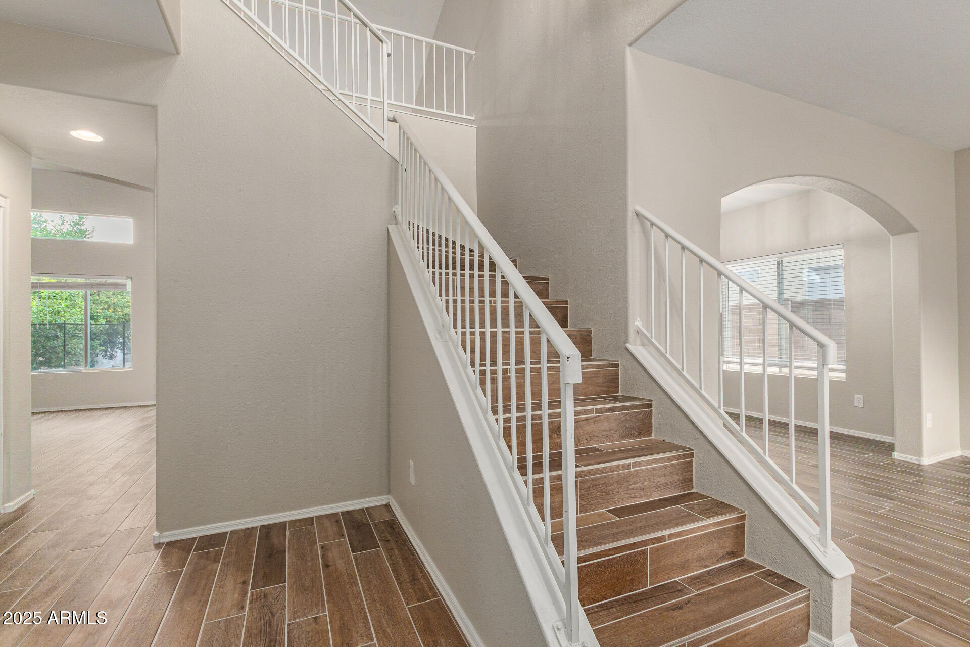 4522 East Rowel Road Phoenix, AZ 85050 - Photo 10 of 49 a view of staircase with wooden floor and white walls