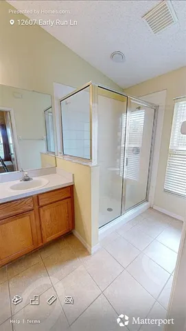 a spacious bathroom with a mirror a shower and a sink