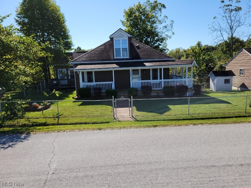 22922 Putney Ridge Road Quaker City, OH 43773 - Photo 5 of 31 View of front of property featuring a front lawn and a porch