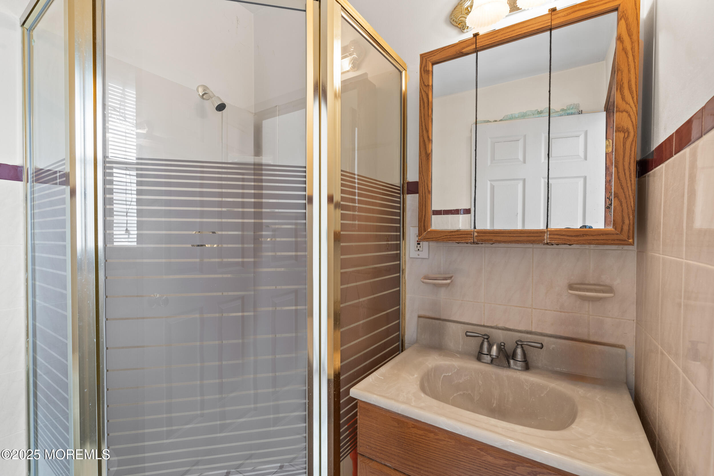 185 Pinecrest Road Oakhurst, NJ 07755 - Photo 14 of 23 a bathroom with a sink and a mirror