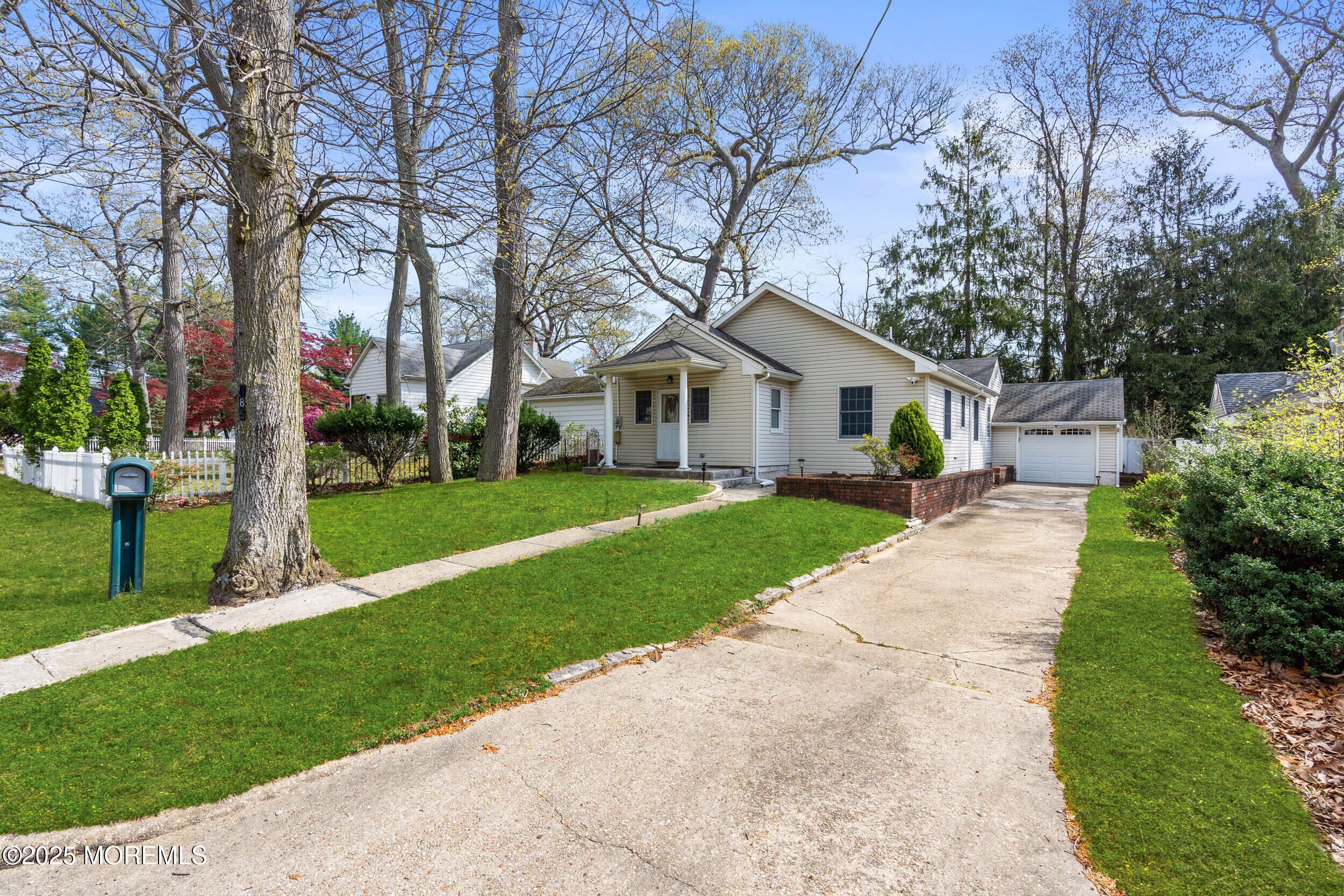 185 Pinecrest Road Oakhurst, NJ 07755 - Photo 16 of 23 a front view of a house with a garden