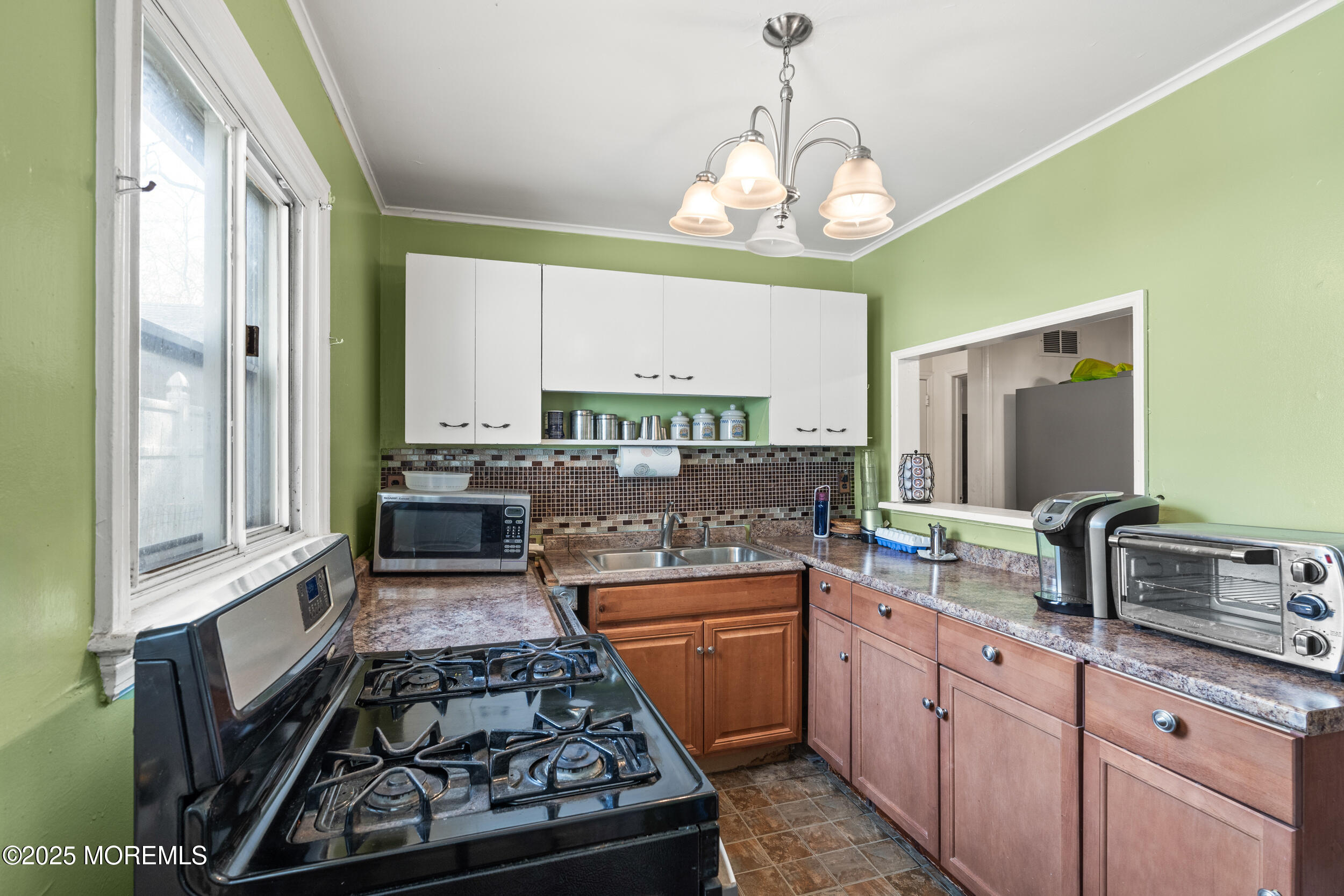 185 Pinecrest Road Oakhurst, NJ 07755 - Photo 6 of 23 a kitchen with kitchen island granite countertop a sink stove and cabinets