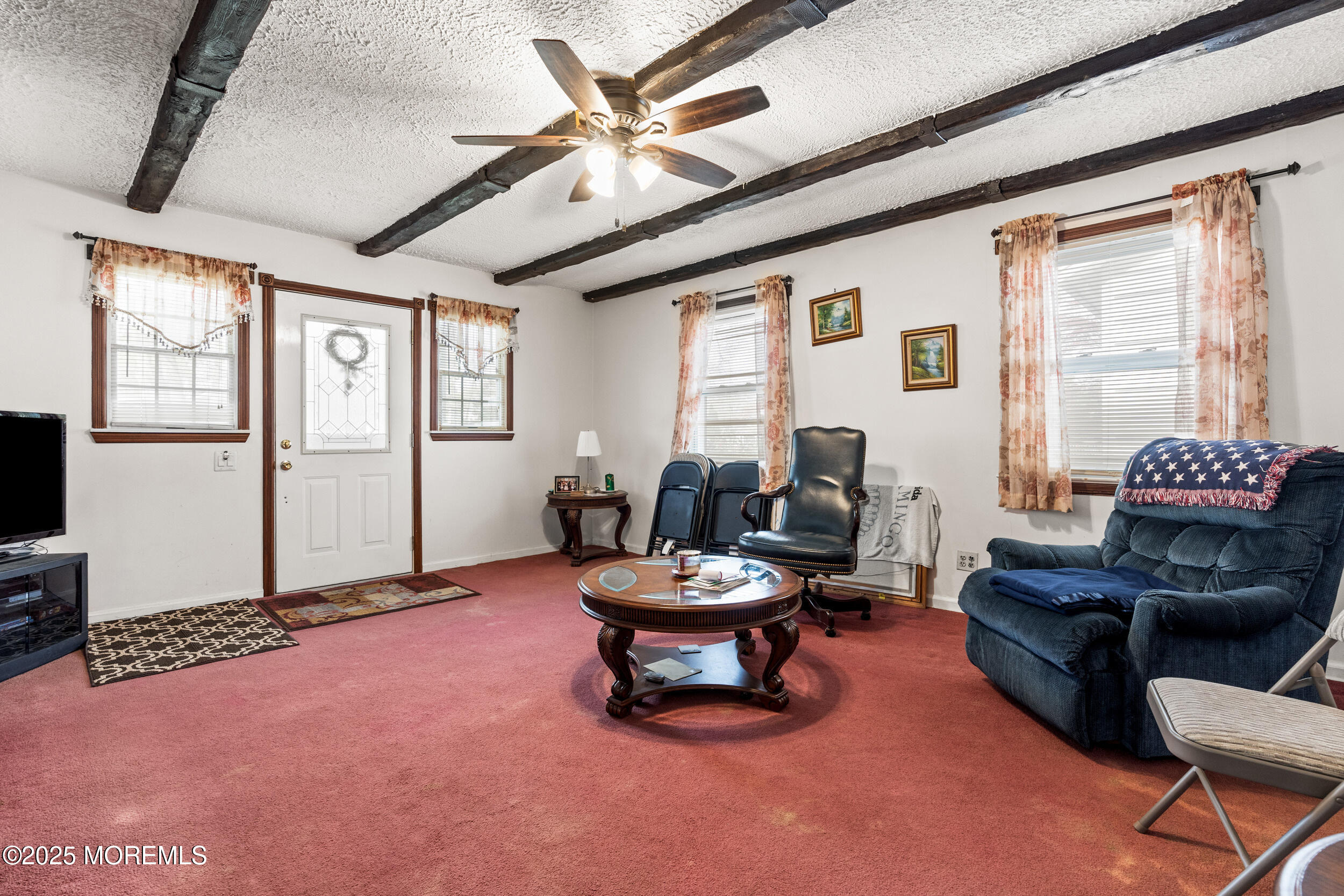 185 Pinecrest Road Oakhurst, NJ 07755 - Photo 6 of 23 a living room with furniture and a large window