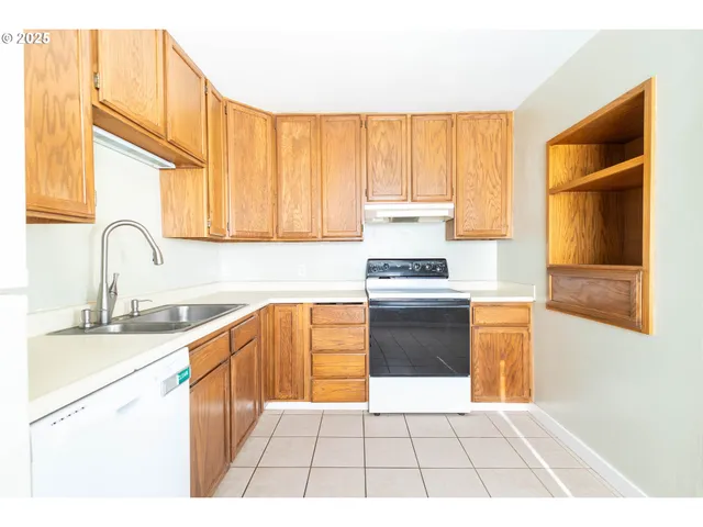 a kitchen with a stove a sink and a microwave