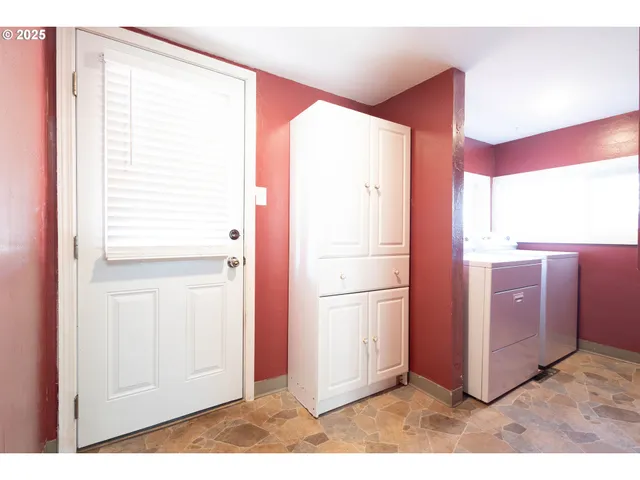 a view of a kitchen with a refrigerator and microwave