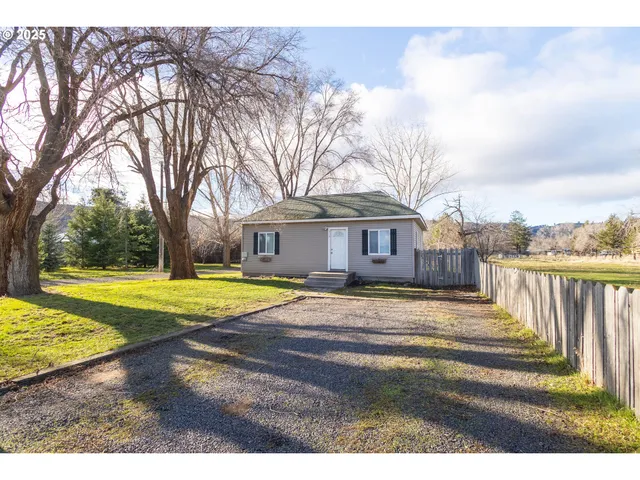 a view of a house with swimming pool and sitting area