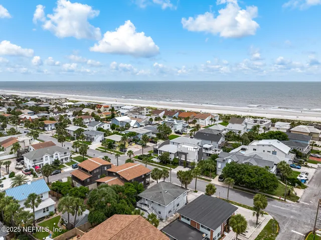 an aerial view of multiple houses with yard