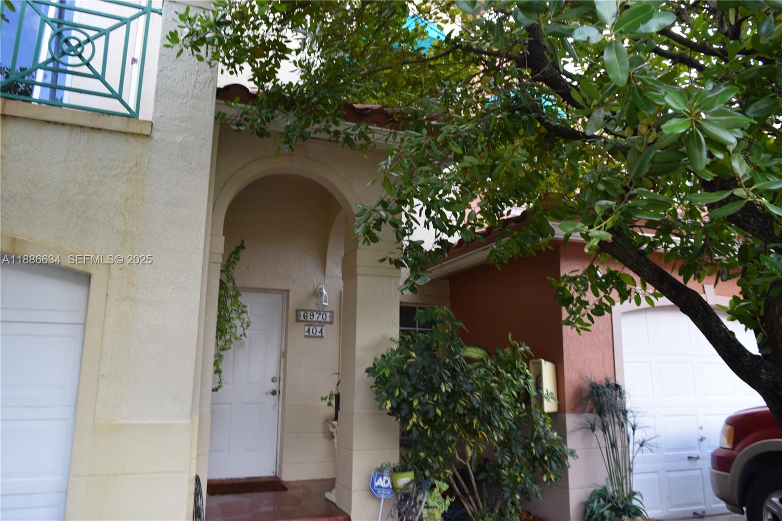 6970 Northwest 174th Terrace, Unit 404 Hialeah, FL 33015 - Photo 1 of 20 view of a house with a tree