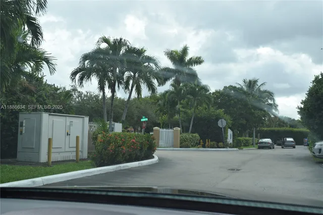 a view of street with a car parked on the road