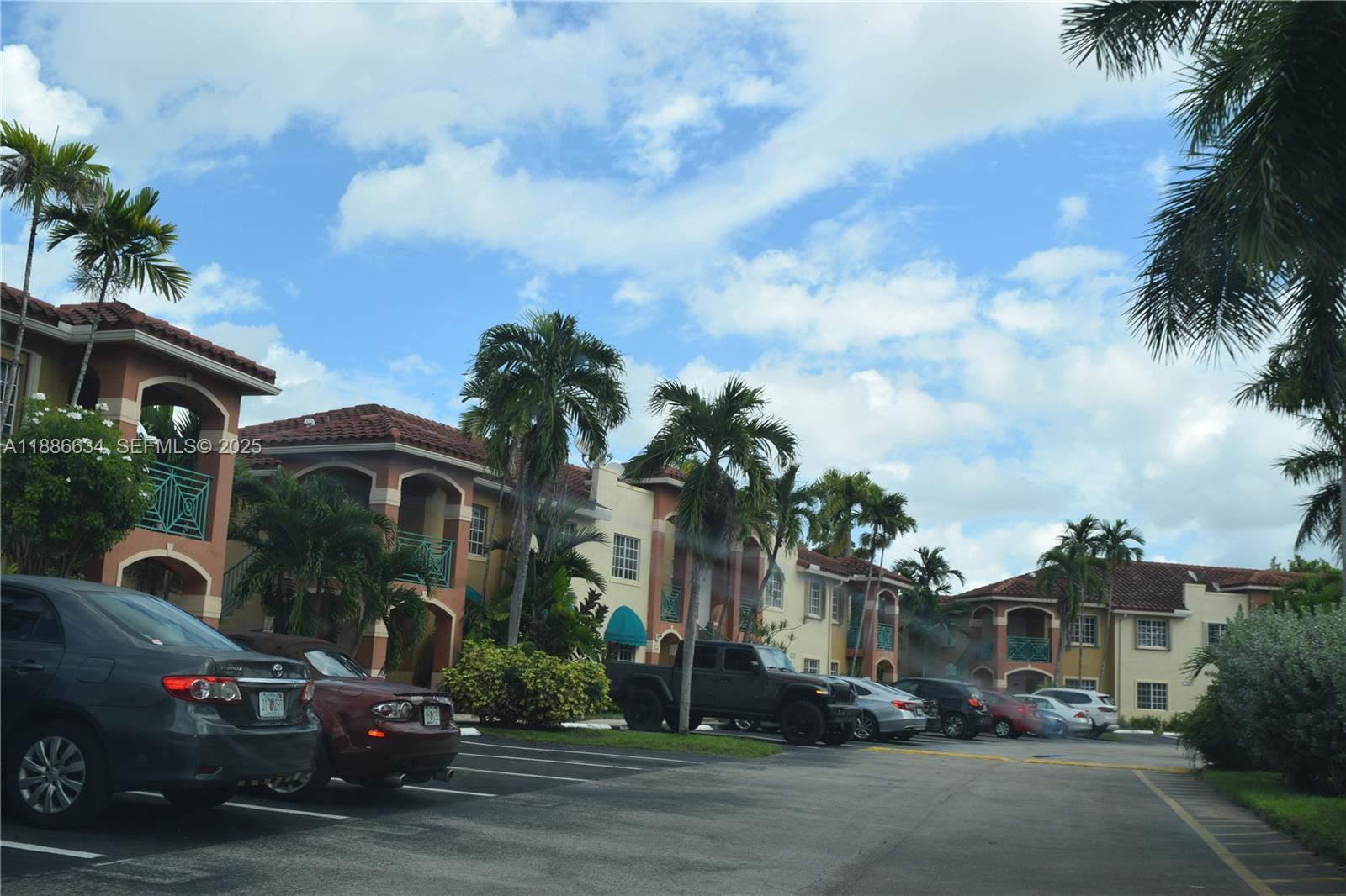 6970 Northwest 174th Terrace, Unit 404 Hialeah, FL 33015 - Photo 20 of 20 a couple of cars parked in front of building