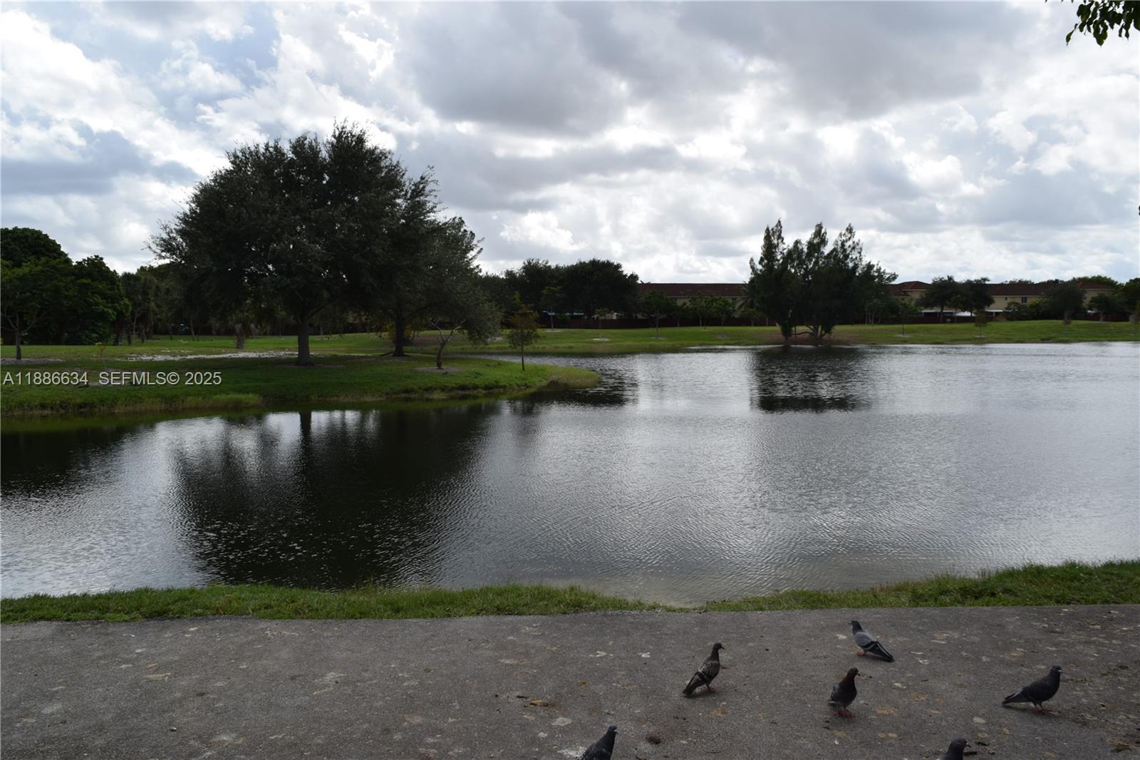 6970 Northwest 174th Terrace, Unit 404 Hialeah, FL 33015 - Photo 2 of 20 a view of a lake