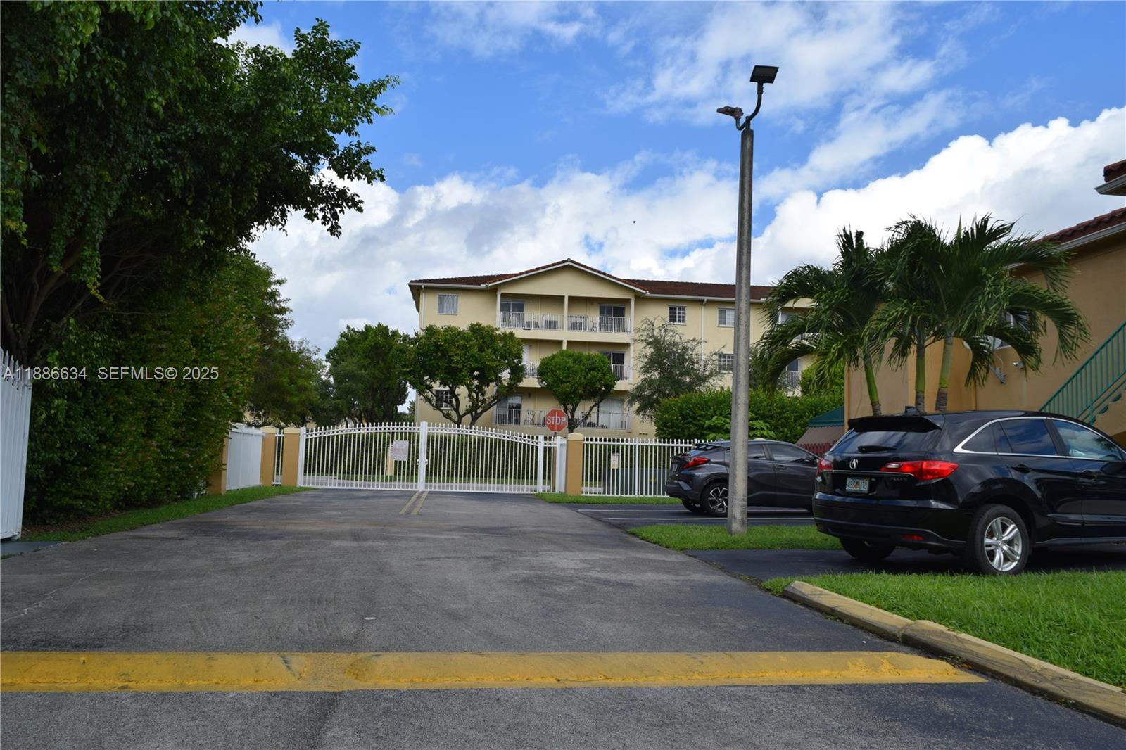 6970 Northwest 174th Terrace, Unit 404 Hialeah, FL 33015 - Photo 3 of 20 a view of street with cars