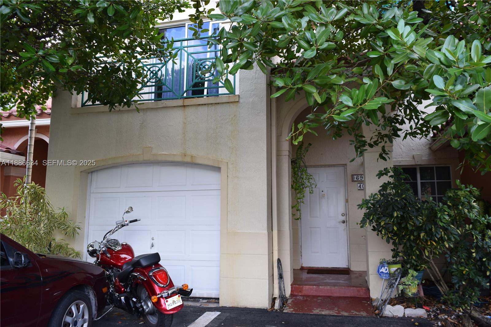 6970 Northwest 174th Terrace, Unit 404 Hialeah, FL 33015 - Photo 6 of 20 front view of a house with a car