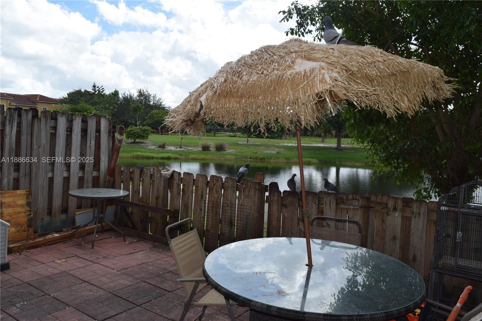 6970 Northwest 174th Terrace, Unit 404 Hialeah, FL 33015 - Photo 7 of 20 a backyard of a house with barbeque oven table and chairs