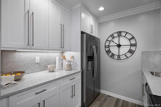 a kitchen with a refrigerator and cabinets