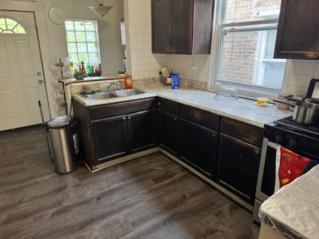 a kitchen with a sink stove and cabinets