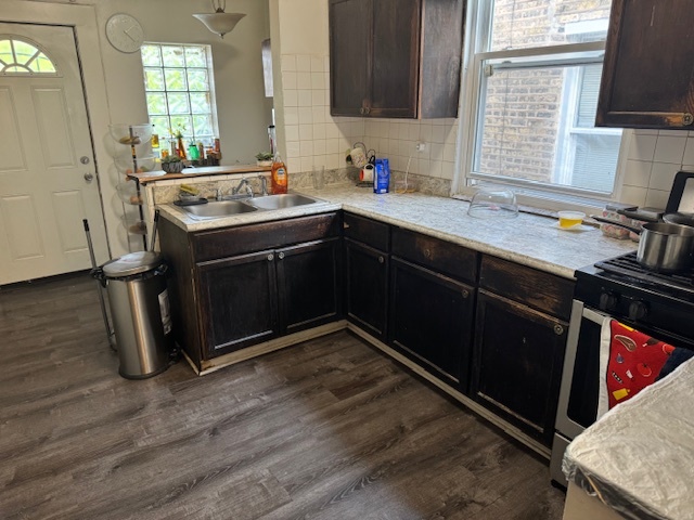 5829 North Washtenaw Avenue Chicago, IL 60659 - Photo 11 of 39 a kitchen with a sink stove and cabinets